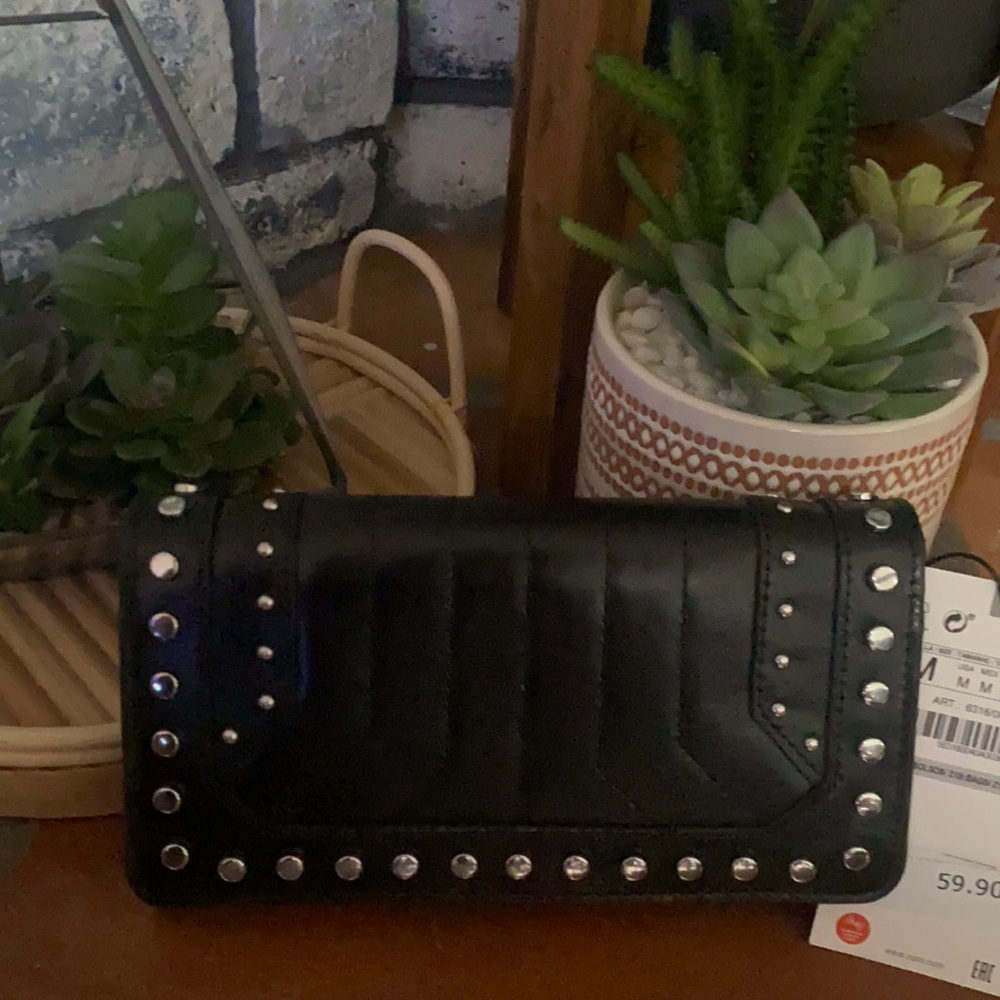 A brand new black mini clutch purse with silver studs never used.
